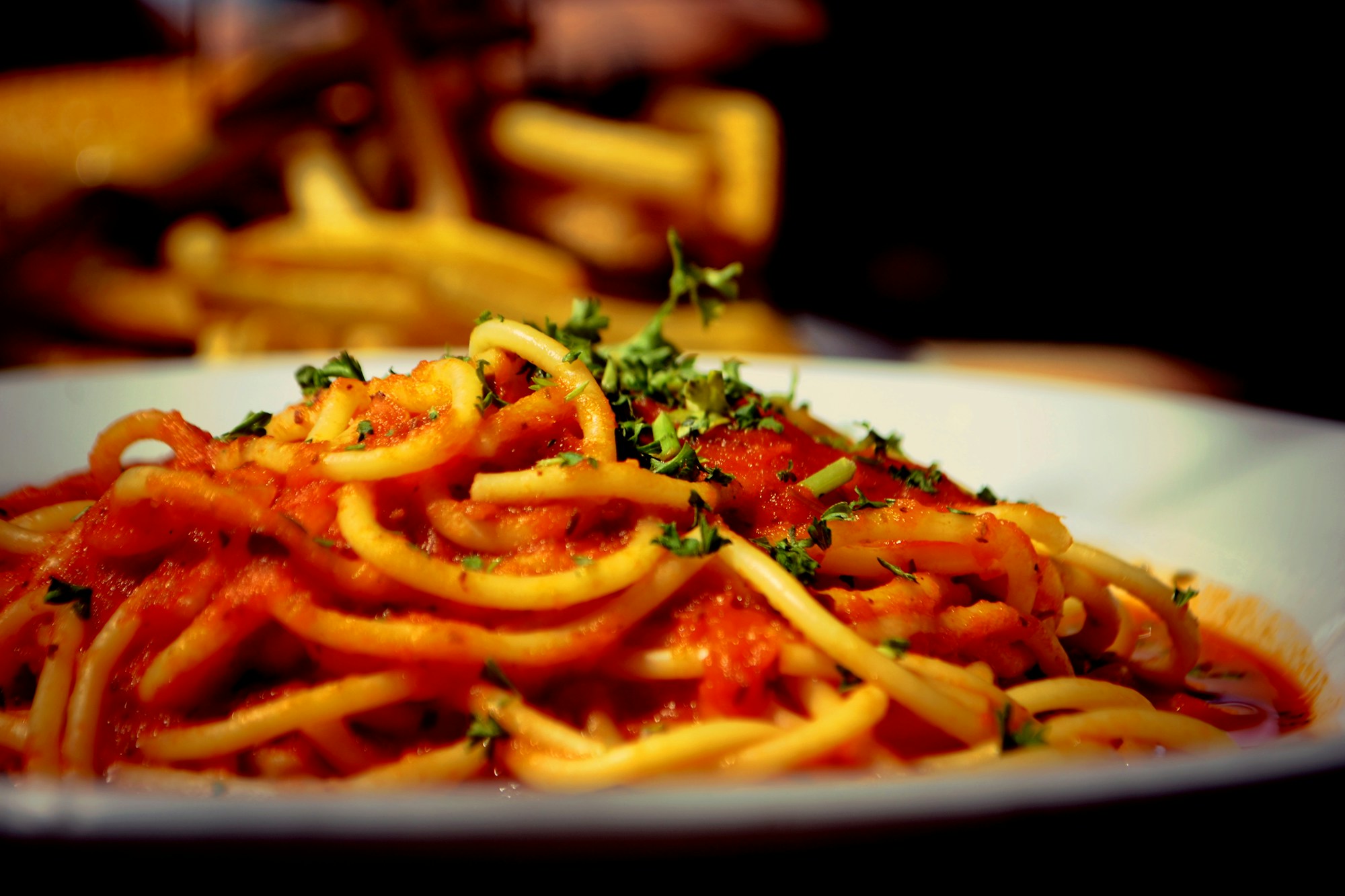 A plate of spaghetti in tomato sauce, the Italian cousin of Napolitan spaghetti